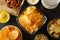 Beer snacks, glass of beer, potato chips, beer nuts, sauces, glass of beer on wooden background