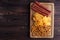 Beer snacks set. Top view on wooden board with salami, chips and