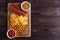 Beer snacks set. Top view of wooden board with salami, chips and