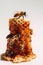 bees sit on a stack of honeycombs on a light background.