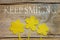 Beeswax, three flowers on wooden table, keep smiling