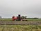 A beet harvester is harvesting beets in the countryside in autumn