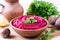 Beet hummus, creamy and delicious in a ceramic bowl