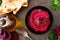 Beet hummus dip, top view scene with flat bread and ingredients