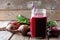 Beet juice in a mason jar with beets over rustic wood