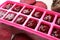 Beet puree in ice cube tray on table, closeup. Ready for freezing