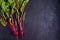 Beet - root vegetables on a black background. Summer farm vegetables. Food background, layout, room for text.