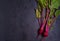 Beet - root vegetables on a black background. Summer farm vegetables. Food background, layout, room for text.