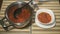 Beet soup is poured in a white plate on the kitchen table