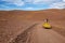 Beetle Volkswagen driving through a desert