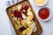 Beetroot carrot and turnip chips, on white ceramic squared tile table background, top view flat lay