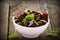 Beetroot chopped for salad with basil and dill seeds in bowl on rustic wooden table