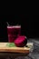 Beetroot on a cutting desk. Beet drink in a glass on a black background. Summer juices. Restaurant beverage, Copy space.