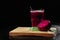 Beetroot on a cutting desk. Beet drink in a glass on a black background. Summer juices. Restaurant beverage, Copy space.