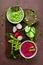 Beetroot and green pea hummus, fresh greens, vegetables, ckackers served on a wooden board, top view