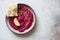 Beetroot  hummus on rustic plate on gray stone background