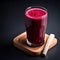 Beetroot juice in glass on wooden table with dark black background. AI generative.