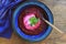 Beetroot mashed soup with sour cream over wooden background, top view