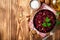 Beetroot salad with wallnuts and garlic in bowl on wooden table