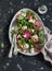 Beets salad with arugula, feta cheese and walnuts. On a dark background