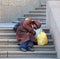 A beggar sleeping on the stairs