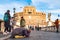 Beggar woman asking alms on her knees on Ponte Sant `Angelo, Bridge of Hadrian full of walking people with Castel Sant `Angelo,