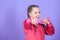 Beginner dumbbell exercises. Child hold little dumbbell violet background. Sport for teens. Easy exercises with dumbbell