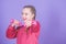 Beginner dumbbell exercises. Child hold little dumbbell violet background. Sport for teens. Easy exercises with dumbbell