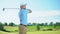 Beginner golf player taking swing hitting ball, rejoicing successful shot, luck