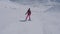 Beginner skier gows down the slope turning left and right