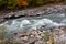 The beginning of autumn in a mountainous area, a river and a forest.