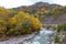 The beginning of autumn in a mountainous area, a river and a forest.