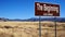 The Beginning brown road sign