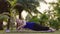 Beginning Fitness Woman Trying to Make Exercise on Yoga Mat in Public Park