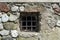 Behind Bars: Vintage Prison Cell with Metal Bars and Rock Brick Wall