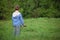 Behind boy ready to kite fly on meadow