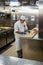 Behind the scenes view of food preparation in the kitchen, galley on board a large cruise ship at Sea in Queen Victoria