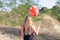 Behind view of young woman with balloon