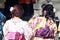 Behind of women in Kimono dress and deep pink sash in Japanese temple.