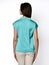 From behind. Young beautiful woman posing in blue mint shirt and gray pants on a white