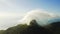 Behold the beauty of the skies. 4k drone footage of clouds around a mountaintop along the coast.