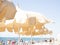 Beige beach umbrellas against the backdrop of a sunny sky