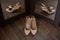 Beige bride shoes on a wooden floor and two reflection in the mirror