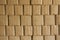 Beige cardboard boxes stand in stack. rough surface texture