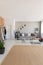 Beige carpet in modern living room interior with grey couch, industrial wooden coffee table and stylish lamp