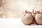 Beige christmas balls with brown ornaments and bows on glitter bokeh backdrop. Christmas holiday and festive decoration