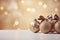 Beige christmas balls with brown ornaments and bows on glitter bokeh backdrop. Christmas holiday and festive decoration