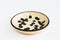 Beige clay plate with black spots. made of layer, covered with transparent glaze. two roasting. Handmade ceramics. On a white