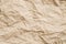 Beige crumpled paper wrinkled texture background