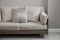 Beige cushion on grey sofa